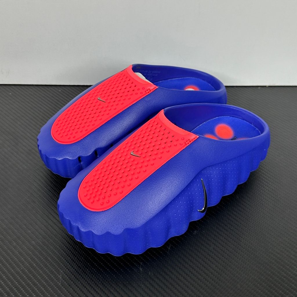 Side profile of the Nike Mind 001 AMP Slide 'Spider-Man' featuring a molded foam construction, iconic red and blue superhero color blocking, subtle web-inspired graphic textures on the strap, and a contoured footbed for all-day comfort.