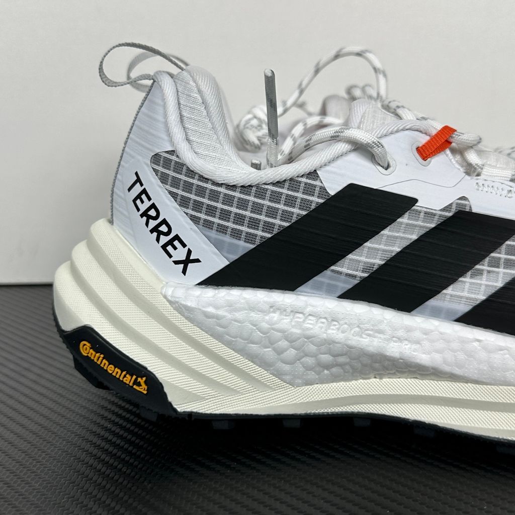 Side profile of the adidas Terrex Freehiker 3 Low GORE-TEX sneaker featuring a breathable white mesh upper equipped with a waterproof membrane, durable black synthetic overlays, and a rugged Continental Rubber outsole with aggressive traction lugs.