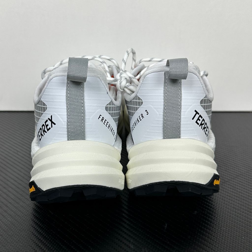 Side profile of the adidas Terrex Freehiker 3 Low GORE-TEX sneaker featuring a breathable white mesh upper equipped with a waterproof membrane, durable black synthetic overlays, and a rugged Continental Rubber outsole with aggressive traction lugs.