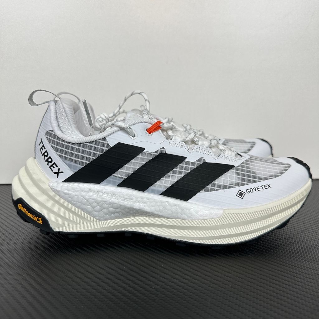 Side profile of the adidas Terrex Freehiker 3 Low GORE-TEX sneaker featuring a breathable white mesh upper equipped with a waterproof membrane, durable black synthetic overlays, and a rugged Continental Rubber outsole with aggressive traction lugs.