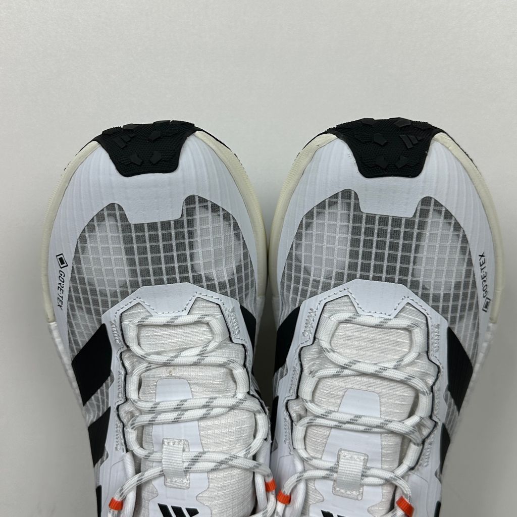 Side profile of the adidas Terrex Freehiker 3 Low GORE-TEX sneaker featuring a breathable white mesh upper equipped with a waterproof membrane, durable black synthetic overlays, and a rugged Continental Rubber outsole with aggressive traction lugs.
