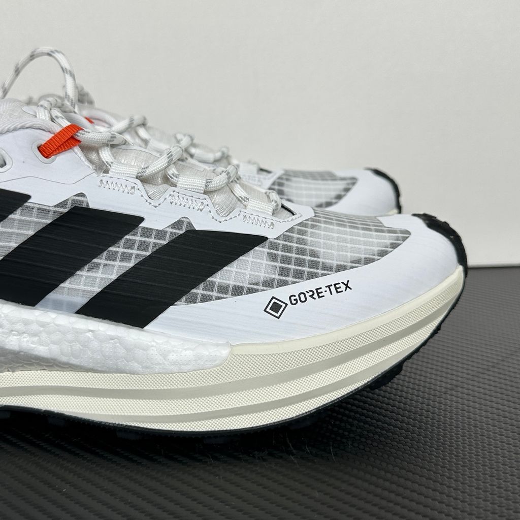 Side profile of the adidas Terrex Freehiker 3 Low GORE-TEX sneaker featuring a breathable white mesh upper equipped with a waterproof membrane, durable black synthetic overlays, and a rugged Continental Rubber outsole with aggressive traction lugs.