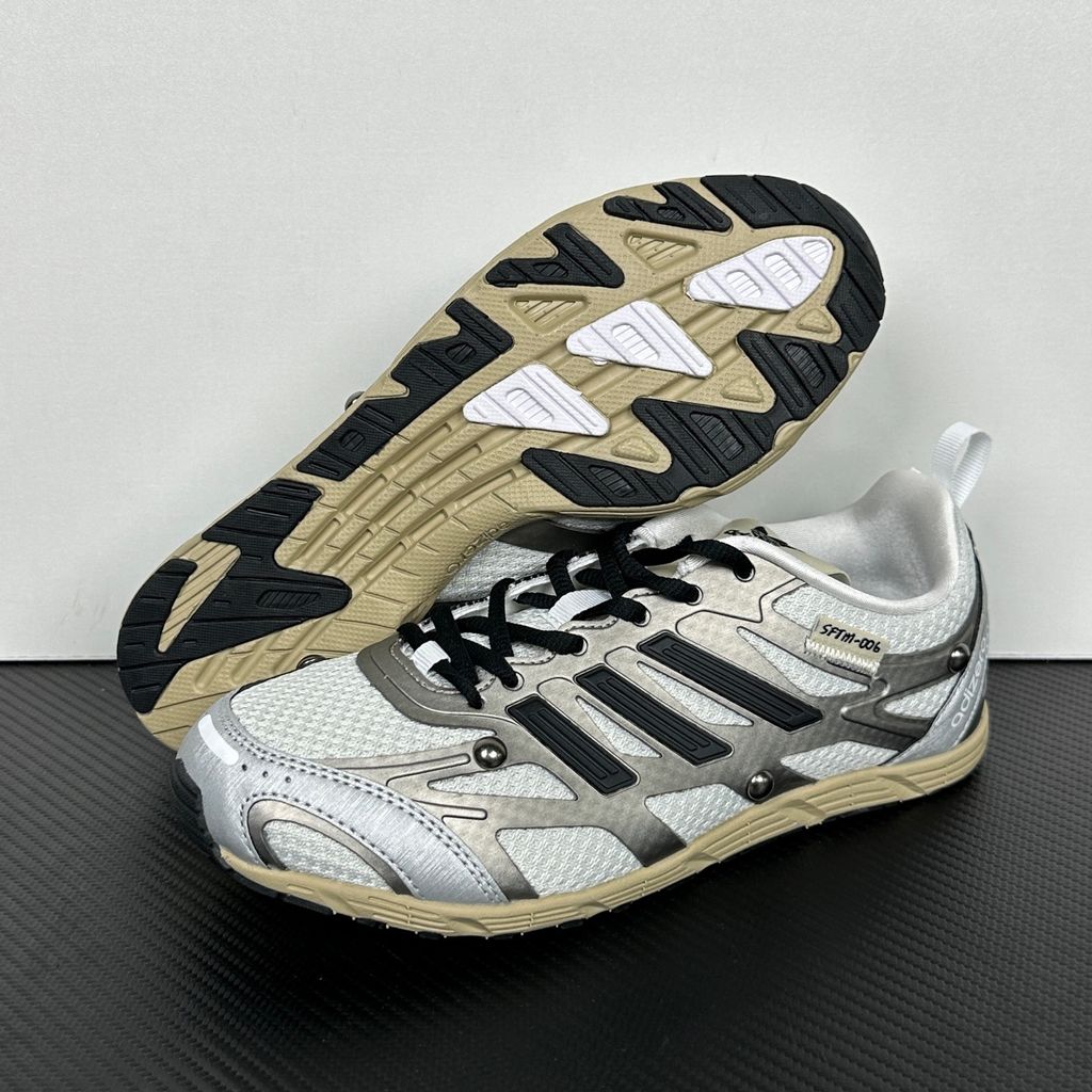 Side profile of the adidas Adizero PR x Song for the Mute collaborative sneaker featuring a crisp white breathable mesh base, gleaming silver metallic synthetic overlays, signature raw-edge and frayed textile accents, and a lightweight cushioned midsole.