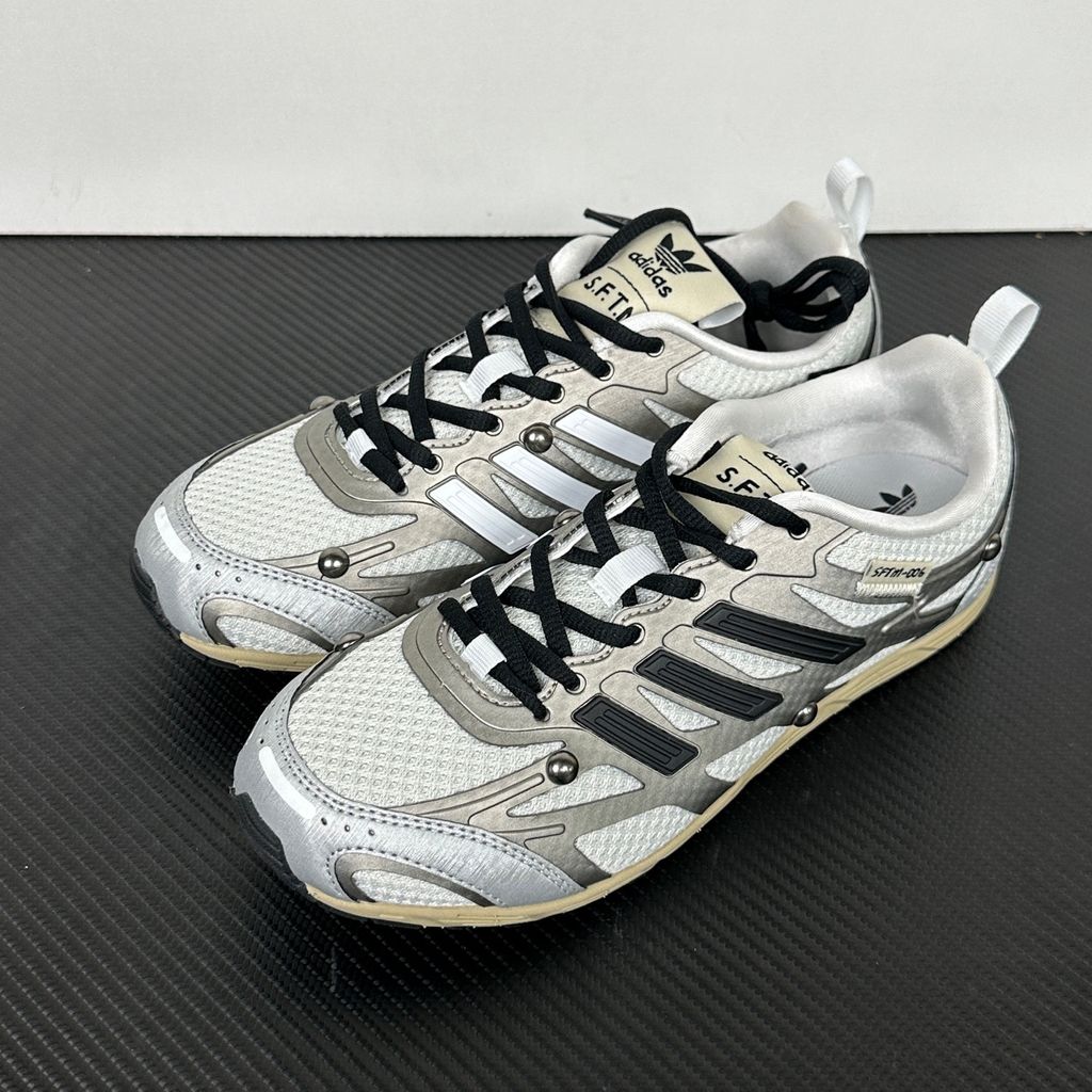 Side profile of the adidas Adizero PR x Song for the Mute collaborative sneaker featuring a crisp white breathable mesh base, gleaming silver metallic synthetic overlays, signature raw-edge and frayed textile accents, and a lightweight cushioned midsole.