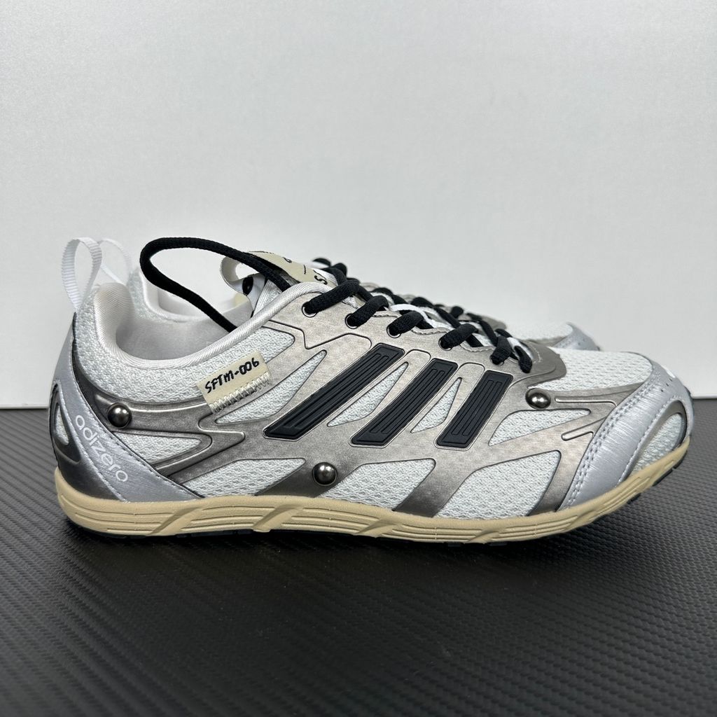 Side profile of the adidas Adizero PR x Song for the Mute collaborative sneaker featuring a crisp white breathable mesh base, gleaming silver metallic synthetic overlays, signature raw-edge and frayed textile accents, and a lightweight cushioned midsole.