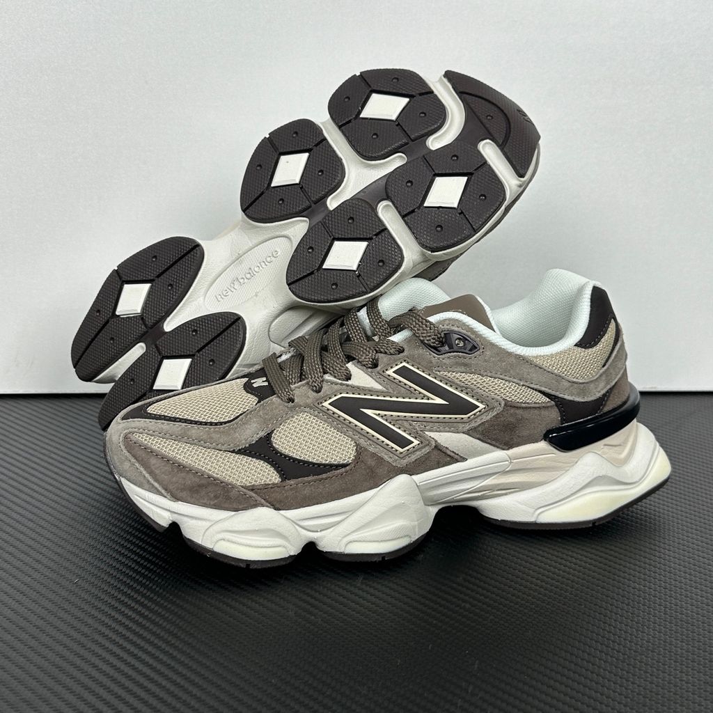 Side profile of the New Balance 9060 sneaker featuring a breathable thunder grey mesh base, rich brown premium suede and nubuck overlays, stonewear accents, the classic 'N' logo, and an exaggerated, sculpted chunky midsole.