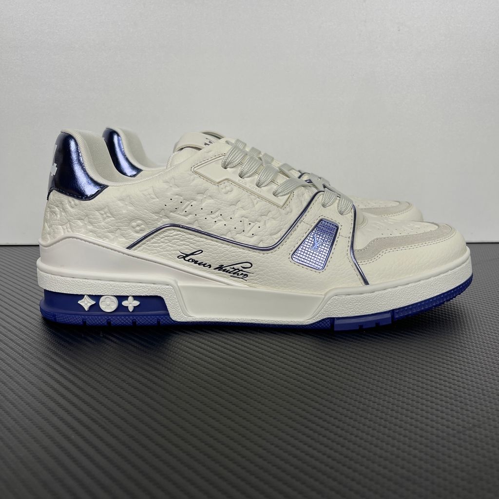 Side profile of Louis Vuitton LV Trainer Sneaker in Marine navy 1AKCPO with Monogram-debossed calf leather and contrasting trim.