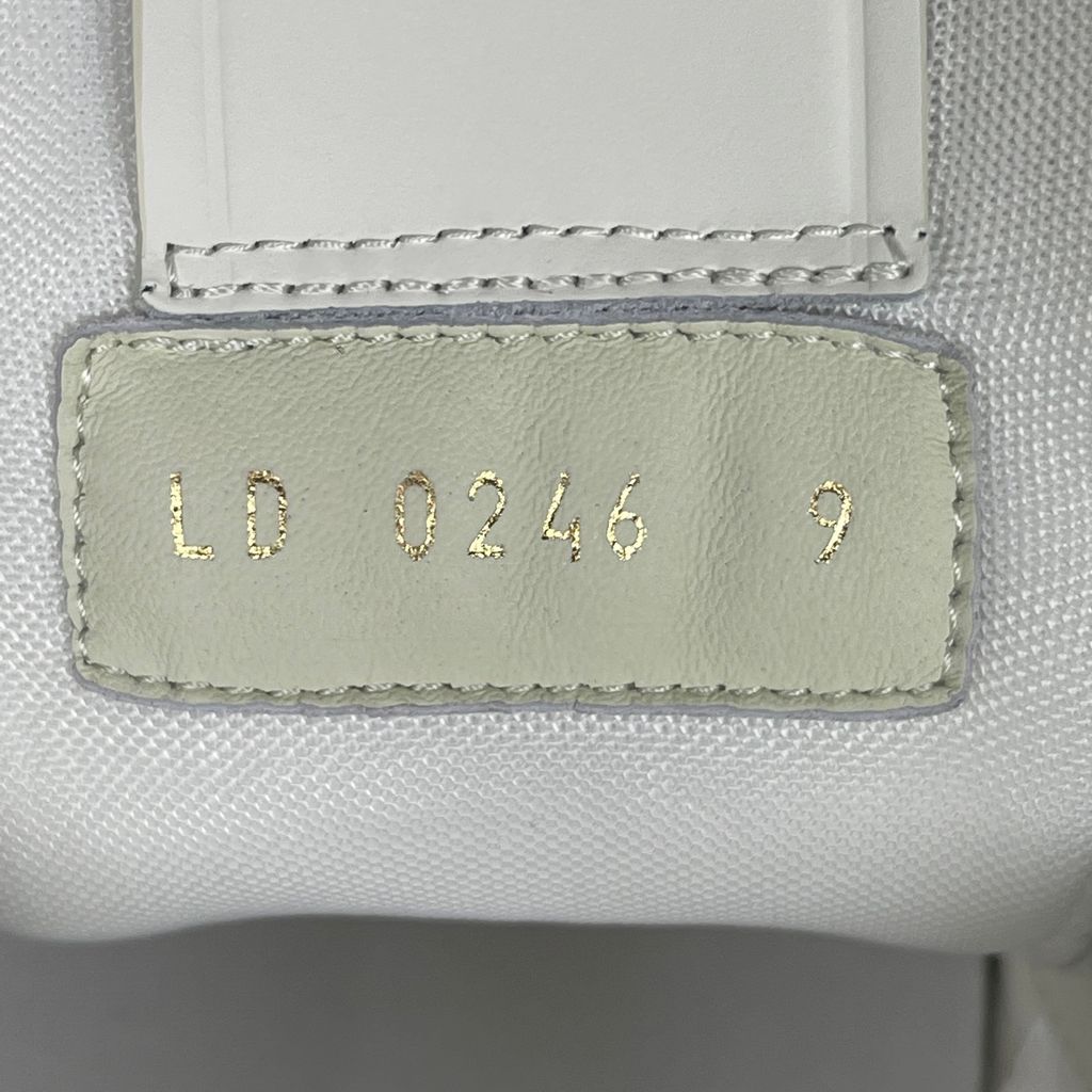 Front three-quarter view of Louis Vuitton LV Trainer Marine 1AKCPO showing its layered leather upper and lace-up construction.
