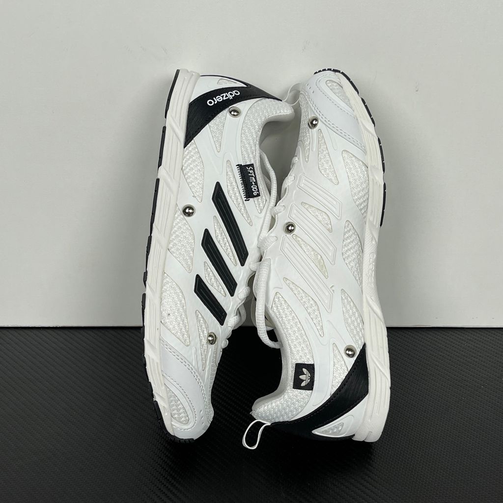 Alt text: Side profile of adidas Adizero PR x Song for the Mute HP3524 in white and black with mesh panels, Three Stripes and silver-tone studs.