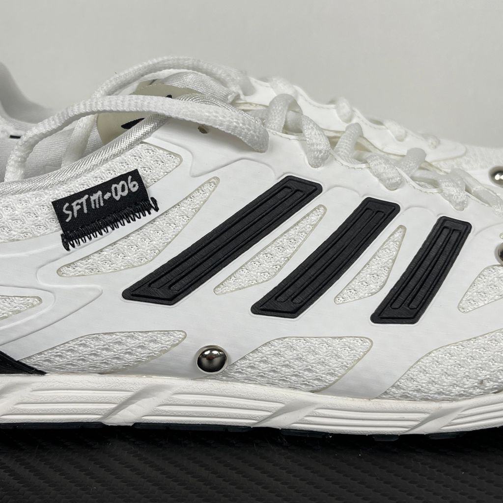 Alt text: Side profile of adidas Adizero PR x Song for the Mute HP3524 in white and black with mesh panels, Three Stripes and silver-tone studs.