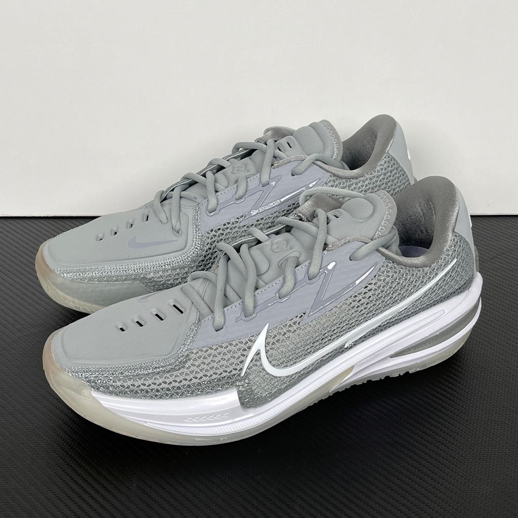 Side profile of Nike Air Zoom G.T. Cut 1 TB Wolf Grey DM5039-003 performance basketball shoe with grey mesh and black Swoosh branding.