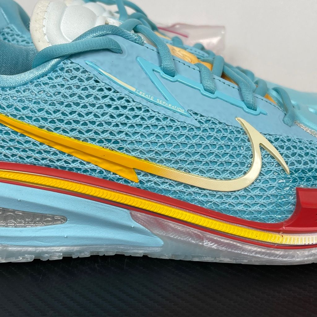 Side profile of Dylan Harper x TITAN x Nike Air Zoom GT Cut Bleached Aqua IU0779-400 with sunrise-gradient Swoosh.