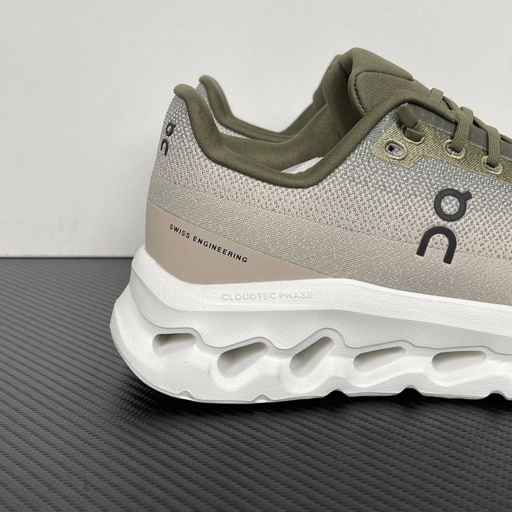 Side profile of men’s On Cloudtilt Olive Desert 3ME10104843 with recycled mesh and CloudTec Phase cushioning.