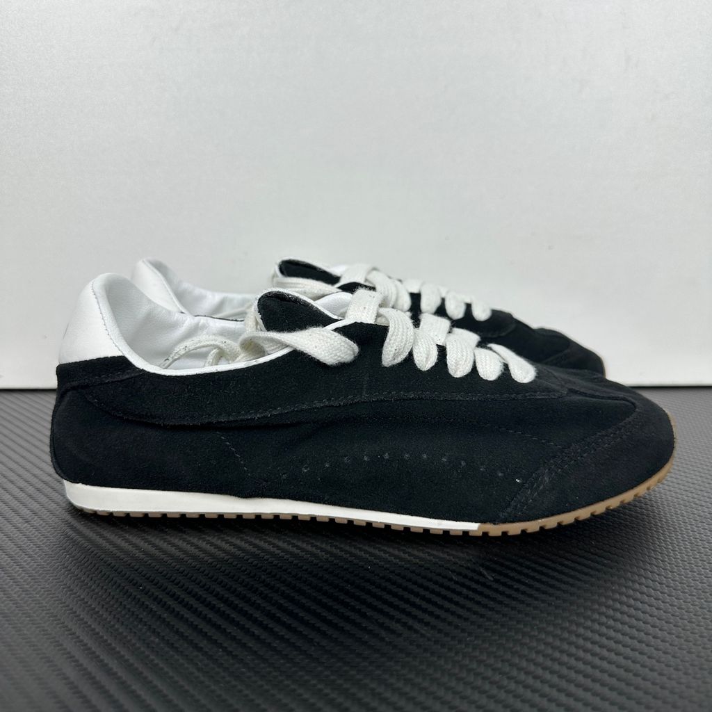 The ALO Sunset Sneaker Black/Ivory (A0891U) is a low-profile lifestyle sneaker inspired by the polished street style of Sunset Boulevard. It combines a black suede upper, contrasting Ivory details, recovery-foam cushioning and a flat gum-rubber outsole.