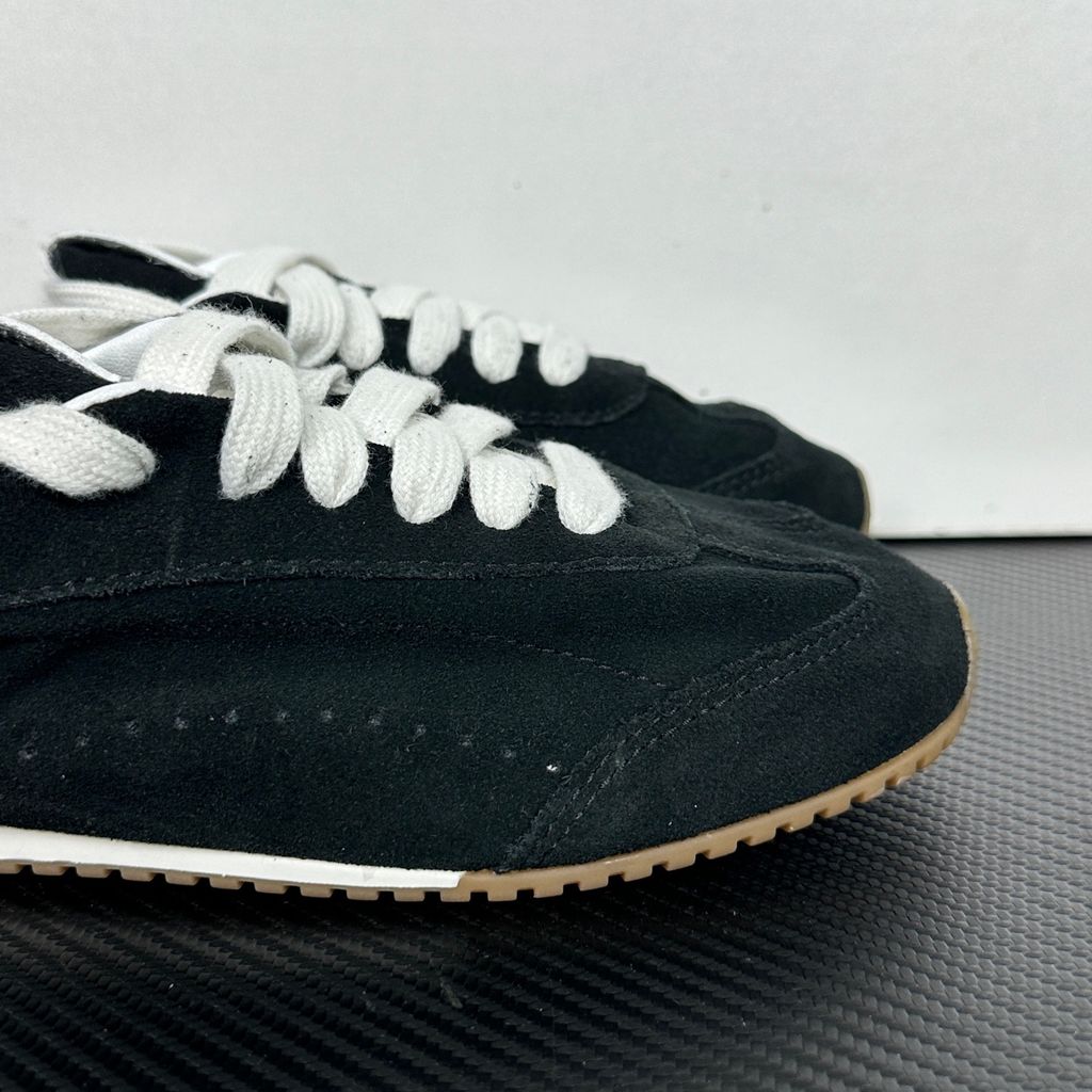 The ALO Sunset Sneaker Black/Ivory (A0891U) is a low-profile lifestyle sneaker inspired by the polished street style of Sunset Boulevard. It combines a black suede upper, contrasting Ivory details, recovery-foam cushioning and a flat gum-rubber outsole.