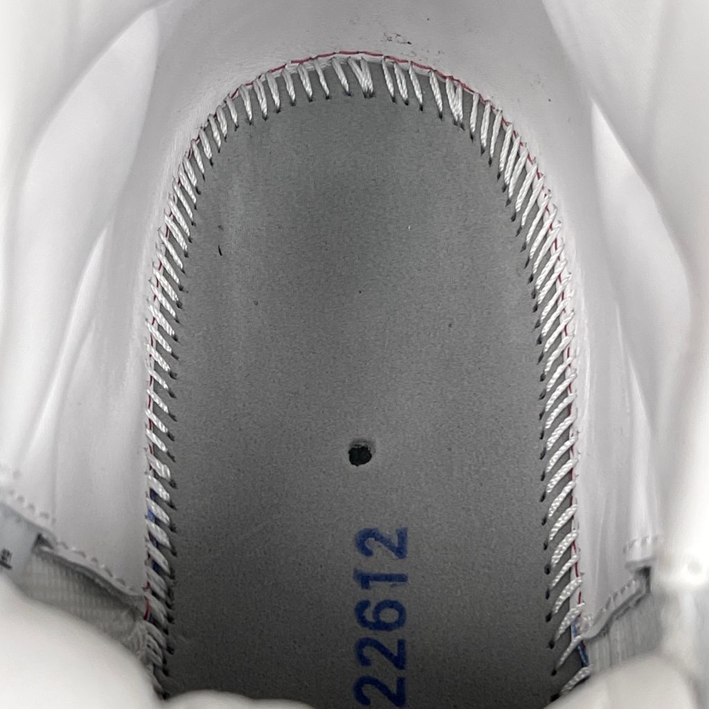 Jordan 11 Retro Comme des Garçons Homme Plus White IV7639-100 sneaker with a premium leather upper, tonal patent mudguard and CDG branding, side view.