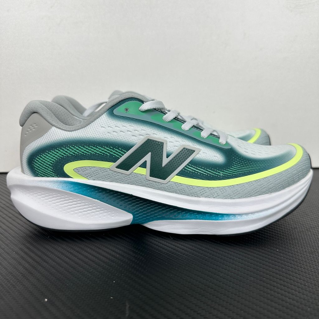 New Balance Ellipse v1 Deep End Glint Blue MELPS4B2 men’s running shoe with a breathable blue mesh upper, Fresh Foam X midsole and green accents, side view.