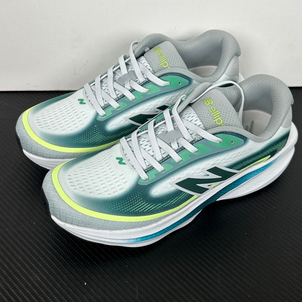 New Balance Ellipse v1 Deep End Glint Blue MELPS4B2 men’s running shoe with a breathable blue mesh upper, Fresh Foam X midsole and green accents, side view.