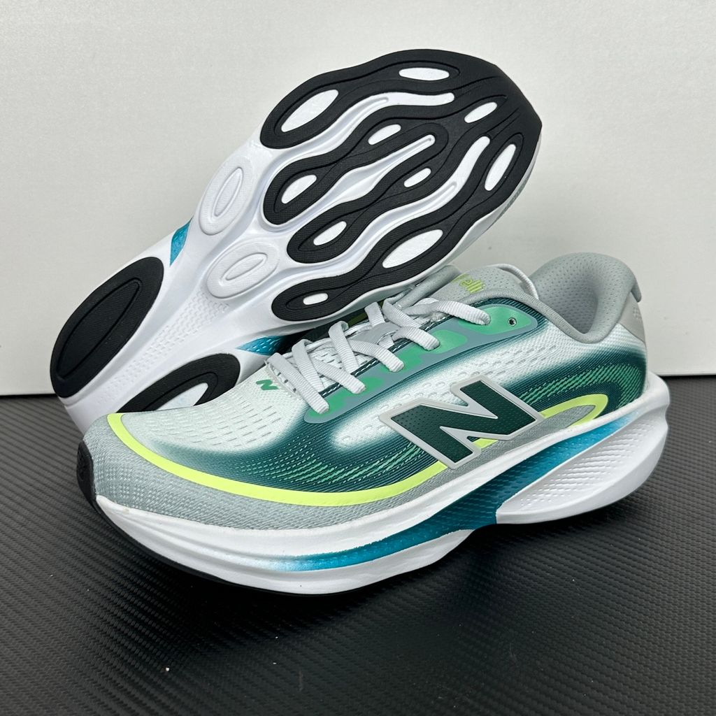 New Balance Ellipse v1 Deep End Glint Blue MELPS4B2 men’s running shoe with a breathable blue mesh upper, Fresh Foam X midsole and green accents, side view.