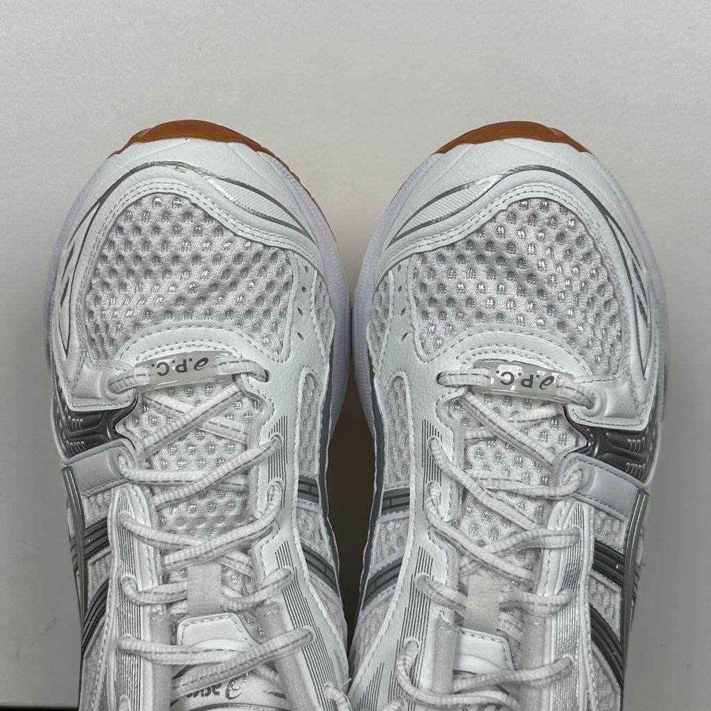 ASICS Gel-Kayano 14 A.P.C. White Pure Silver 1203A727-100 unisex sneaker with white mesh, metallic silver overlays and GEL cushioning, side view.