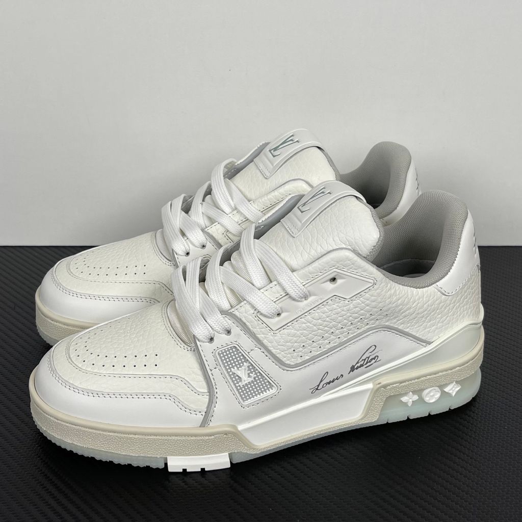 Louis Vuitton LV Trainer White Grey 1A8WAV men’s sneaker with smooth and grained white calf leather, LV branding and Monogram Flower rubber outsole, side view.