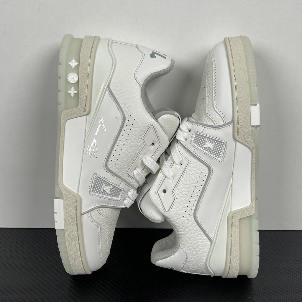 Louis Vuitton LV Trainer White Grey 1A8WAV men’s sneaker with smooth and grained white calf leather, LV branding and Monogram Flower rubber outsole, side view.