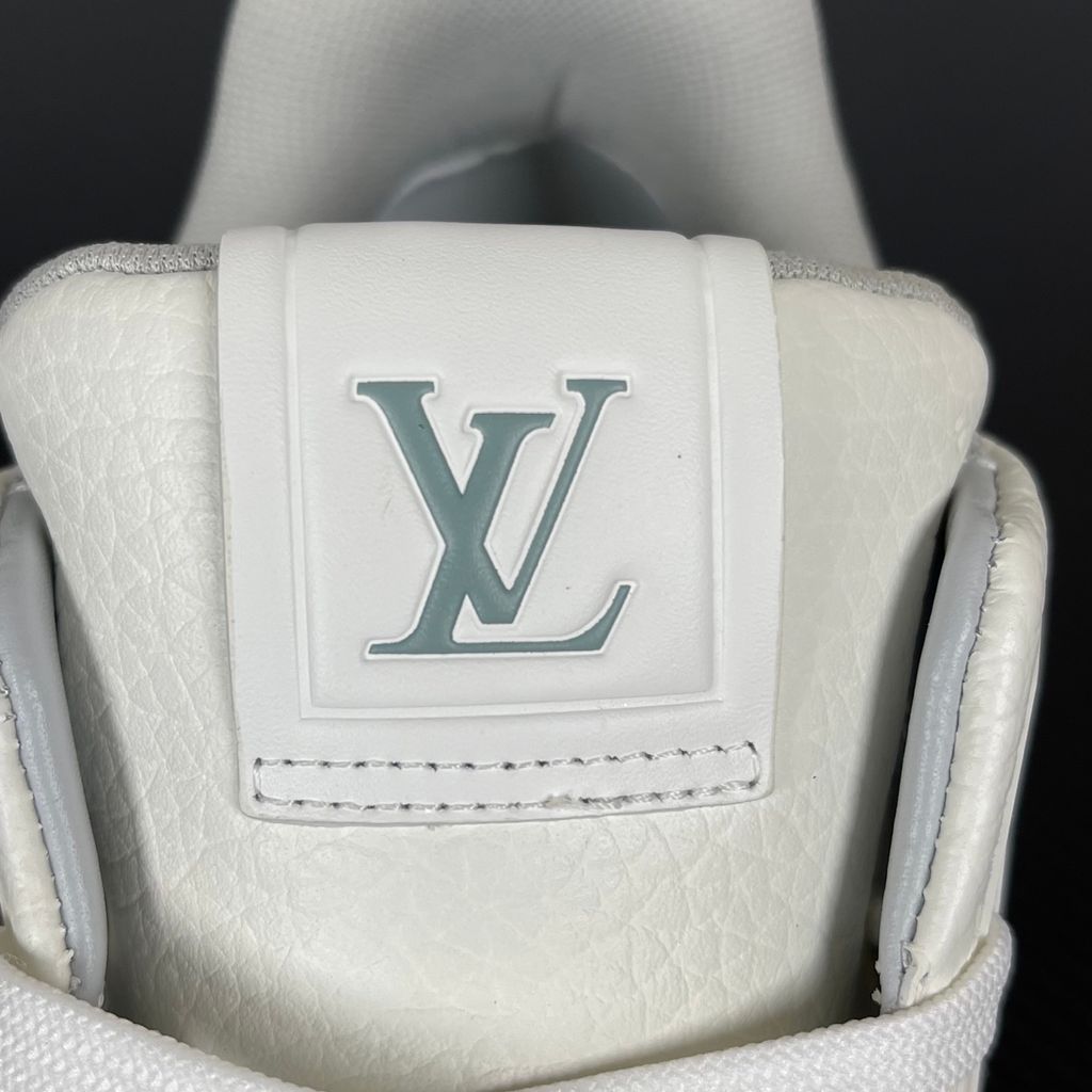 Louis Vuitton LV Trainer White Grey 1A8WAV men’s sneaker with smooth and grained white calf leather, LV branding and Monogram Flower rubber outsole, side view.