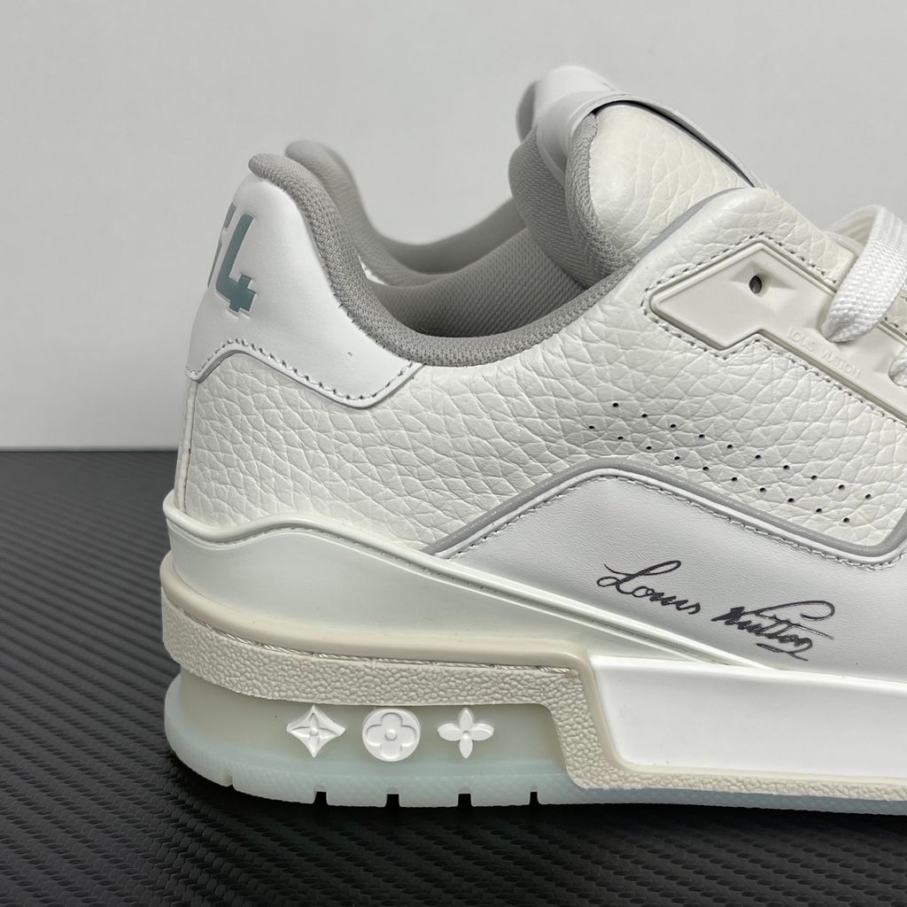 Louis Vuitton LV Trainer White Grey 1A8WAV men’s sneaker with smooth and grained white calf leather, LV branding and Monogram Flower rubber outsole, side view.