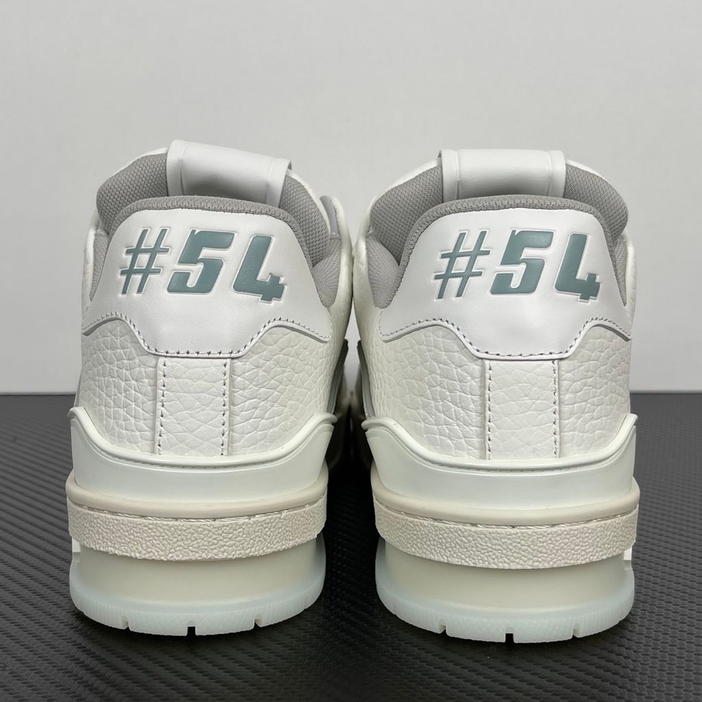 Louis Vuitton LV Trainer White Grey 1A8WAV men’s sneaker with smooth and grained white calf leather, LV branding and Monogram Flower rubber outsole, side view.