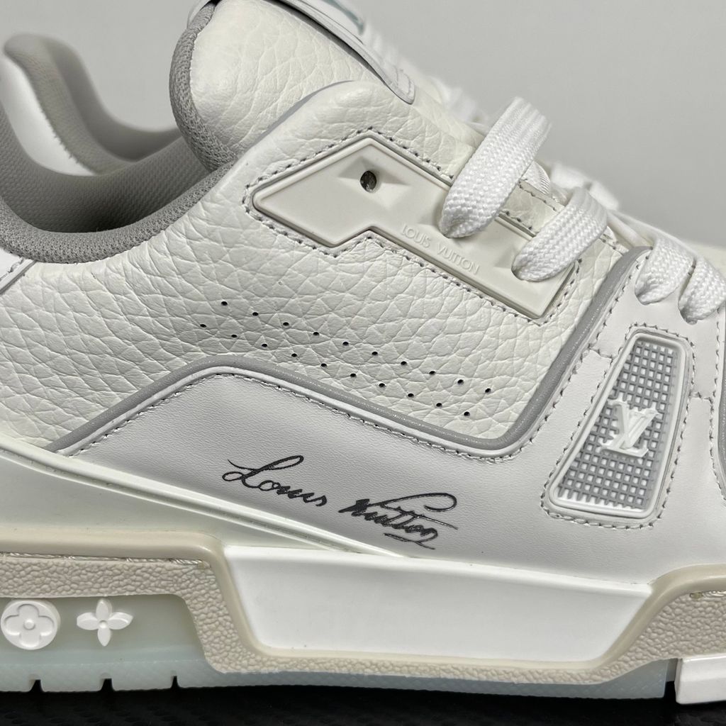 Louis Vuitton LV Trainer White Grey 1A8WAV men’s sneaker with smooth and grained white calf leather, LV branding and Monogram Flower rubber outsole, side view.