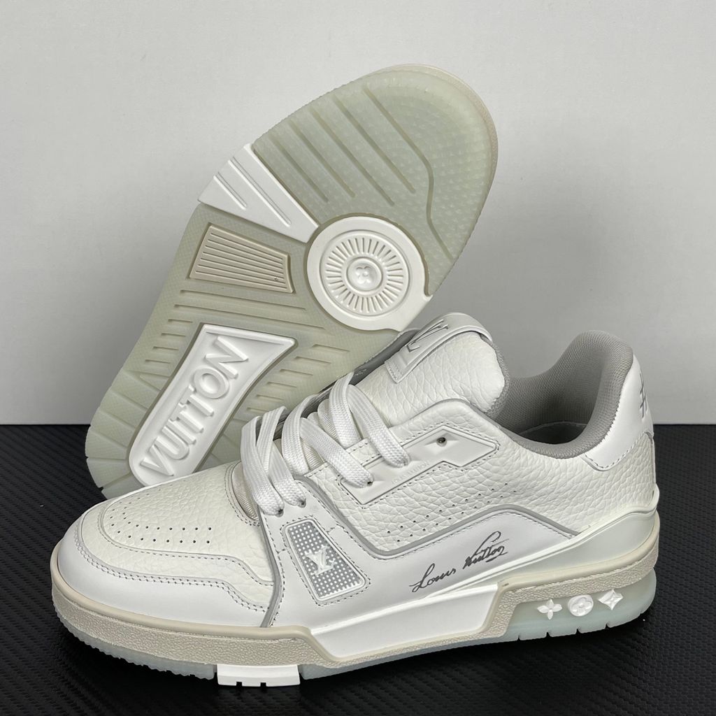 Louis Vuitton LV Trainer White Grey 1A8WAV men’s sneaker with smooth and grained white calf leather, LV branding and Monogram Flower rubber outsole, side view.