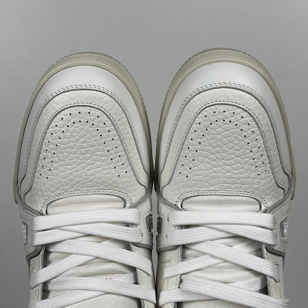 Louis Vuitton LV Trainer White Grey 1A8WAV men’s sneaker with smooth and grained white calf leather, LV branding and Monogram Flower rubber outsole, side view.