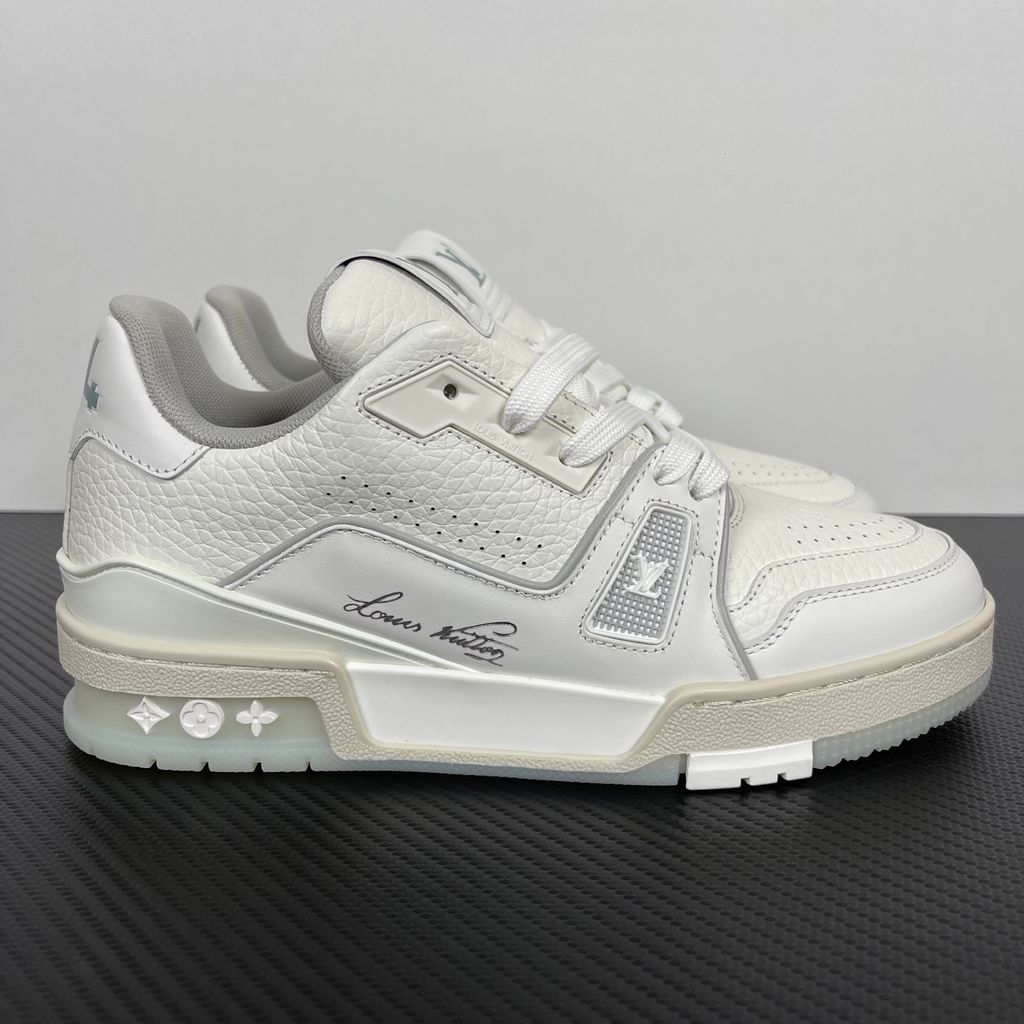Louis Vuitton LV Trainer White Grey 1A8WAV men’s sneaker with smooth and grained white calf leather, LV branding and Monogram Flower rubber outsole, side view.
