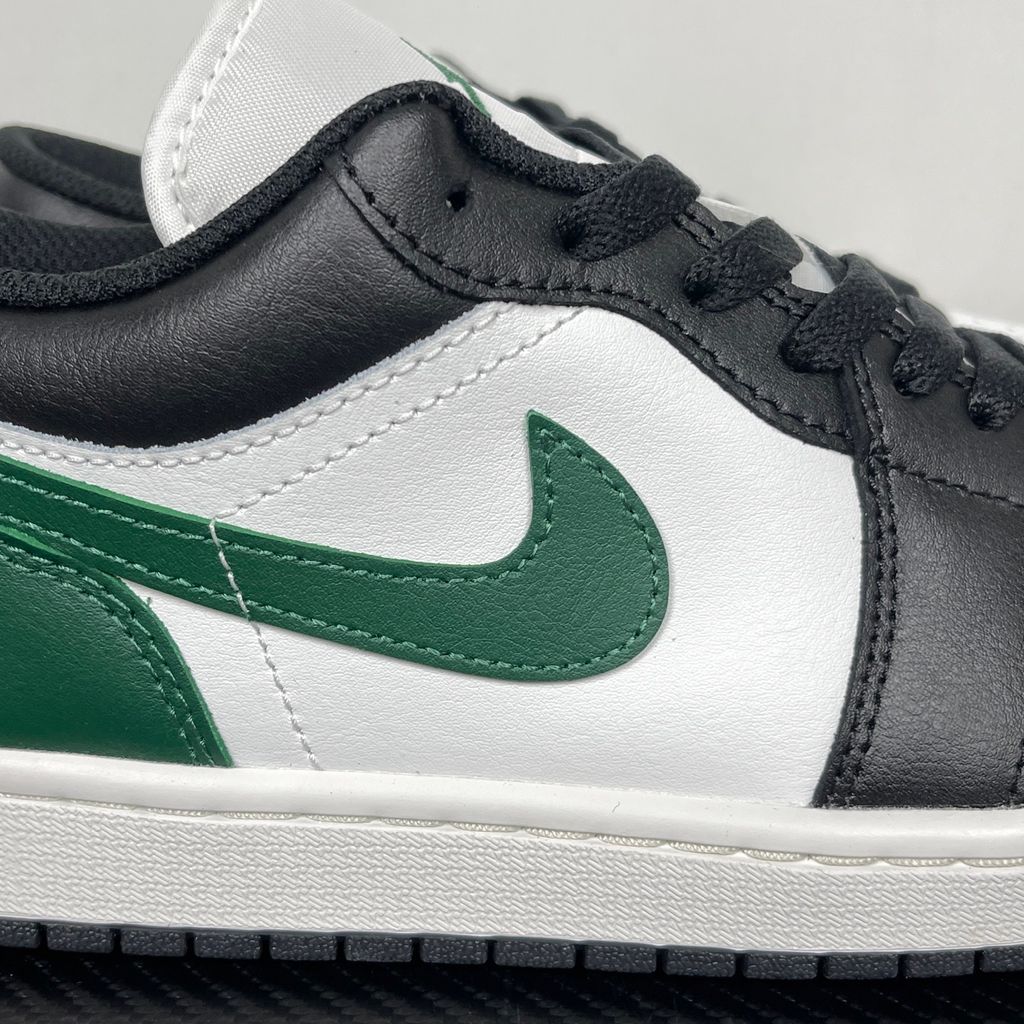 Air Jordan 1 Low Black Gorge Green 553558-047 men’s sneaker with a black leather upper, green accents, Summit White midsole and rubber outsole, side view.