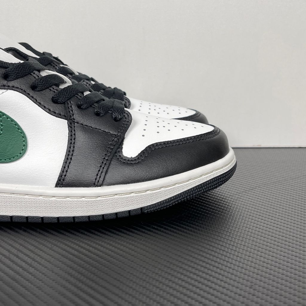 Air Jordan 1 Low Black Gorge Green 553558-047 men’s sneaker with a black leather upper, green accents, Summit White midsole and rubber outsole, side view.