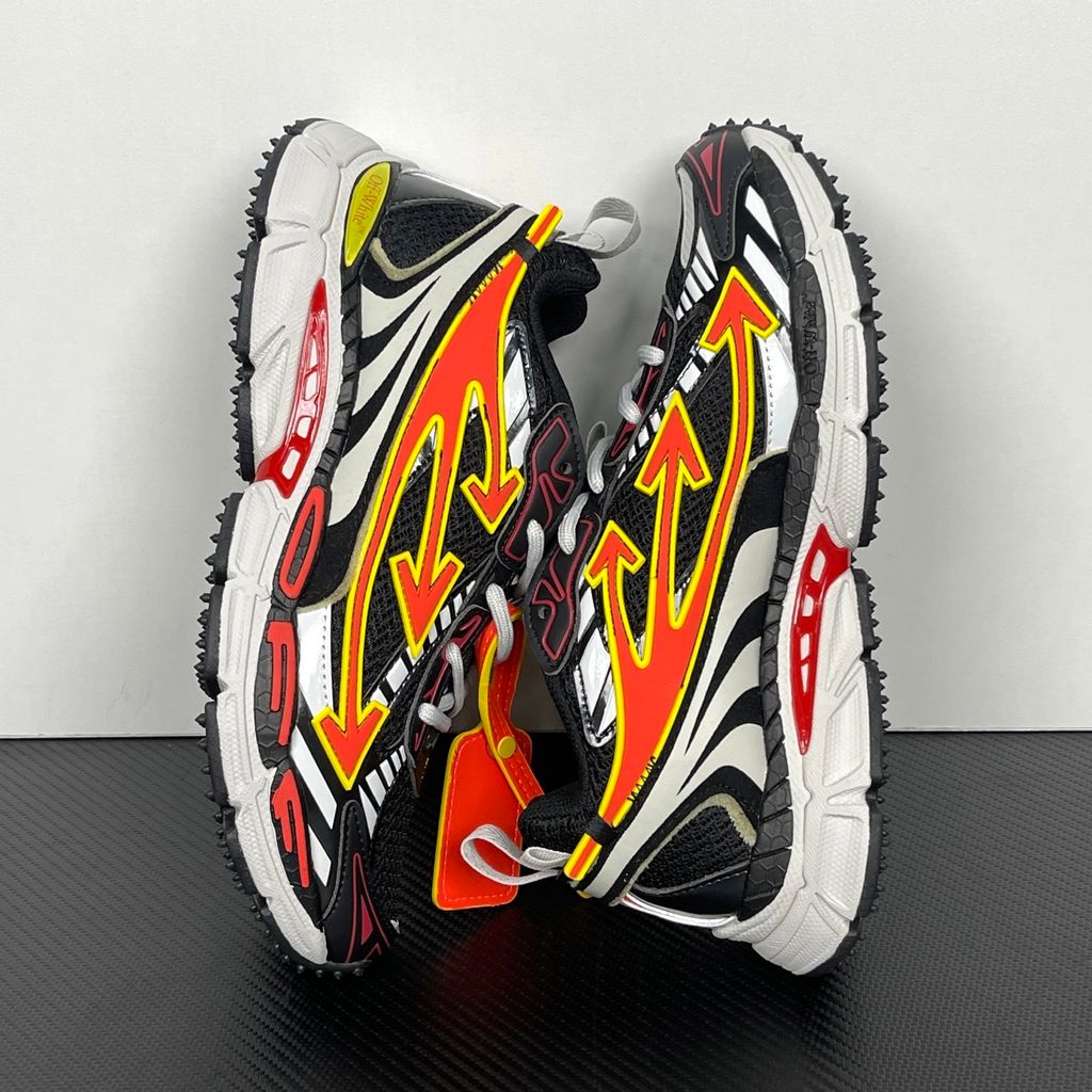 Off-White Be Right Back Black Coral Red OMIA295S26FAB0051026 men’s sneaker with black mesh, coral red and yellow Arrow overlays, silver panels and orange zip tie, side view.