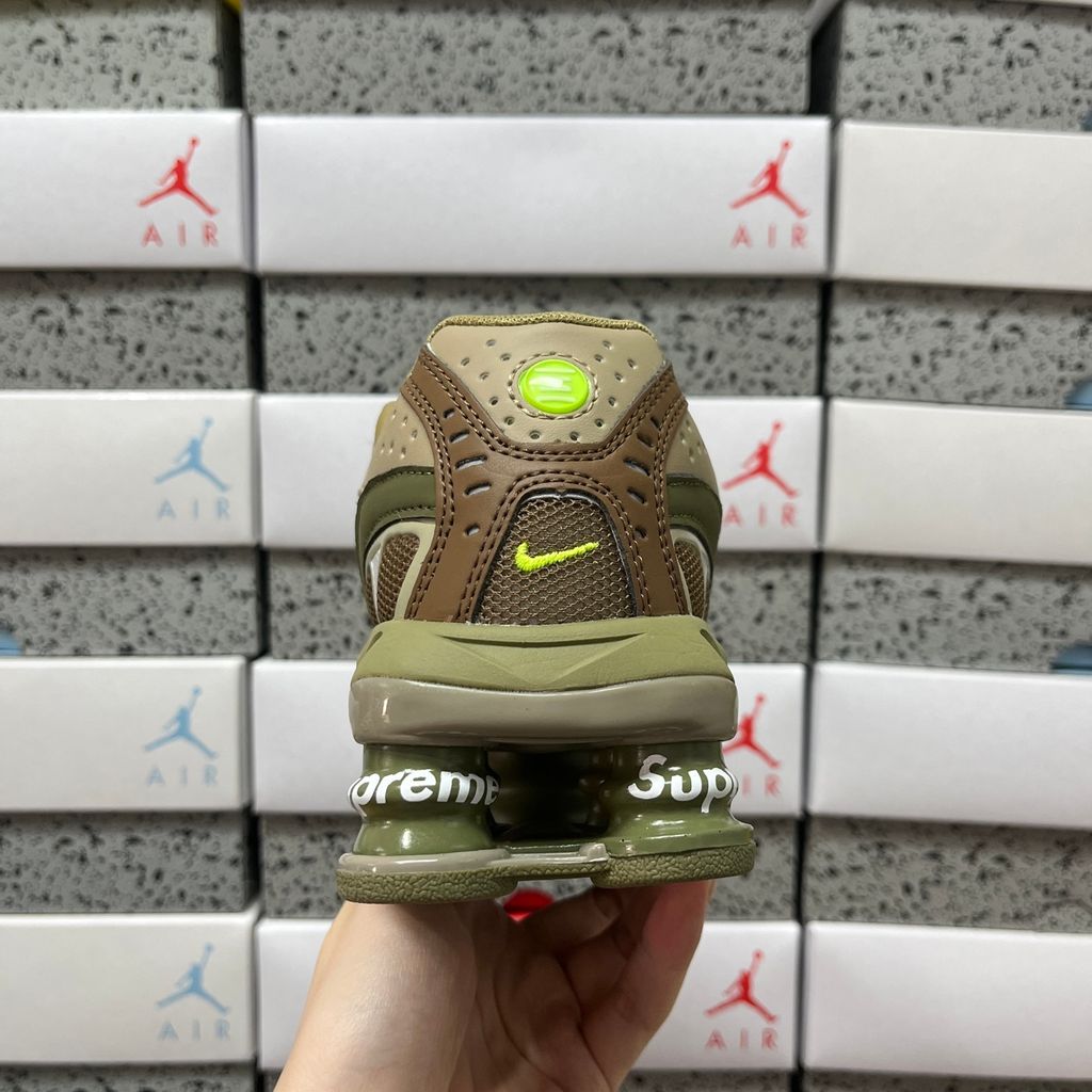 Supreme x Nike Shox Ride 2 Neutral Olive DN1615-200 sneaker with olive mesh, leather and nubuck panels, Electric Green accents and Supreme-branded Shox heel pillars.