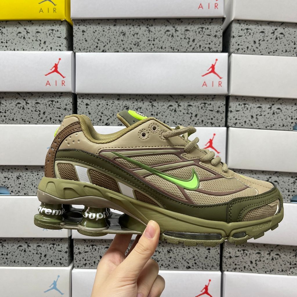 Supreme x Nike Shox Ride 2 Neutral Olive DN1615-200 sneaker with olive mesh, leather and nubuck panels, Electric Green accents and Supreme-branded Shox heel pillars.