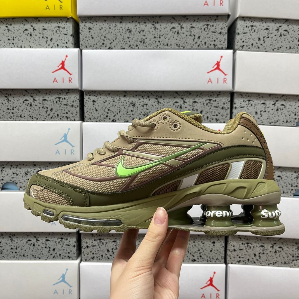 Supreme x Nike Shox Ride 2 Neutral Olive DN1615-200 sneaker with olive mesh, leather and nubuck panels, Electric Green accents and Supreme-branded Shox heel pillars.
