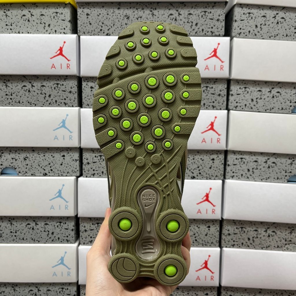Supreme x Nike Shox Ride 2 Neutral Olive DN1615-200 sneaker with olive mesh, leather and nubuck panels, Electric Green accents and Supreme-branded Shox heel pillars.