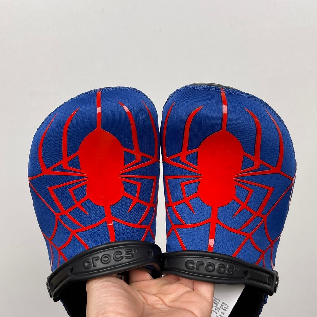 Crocs x Marvel Spider-Man Neo Classic Clog Multi 211489-90H with blue upper, red spider-web graphics, black pivoting heel strap and Spider-Man emblem.