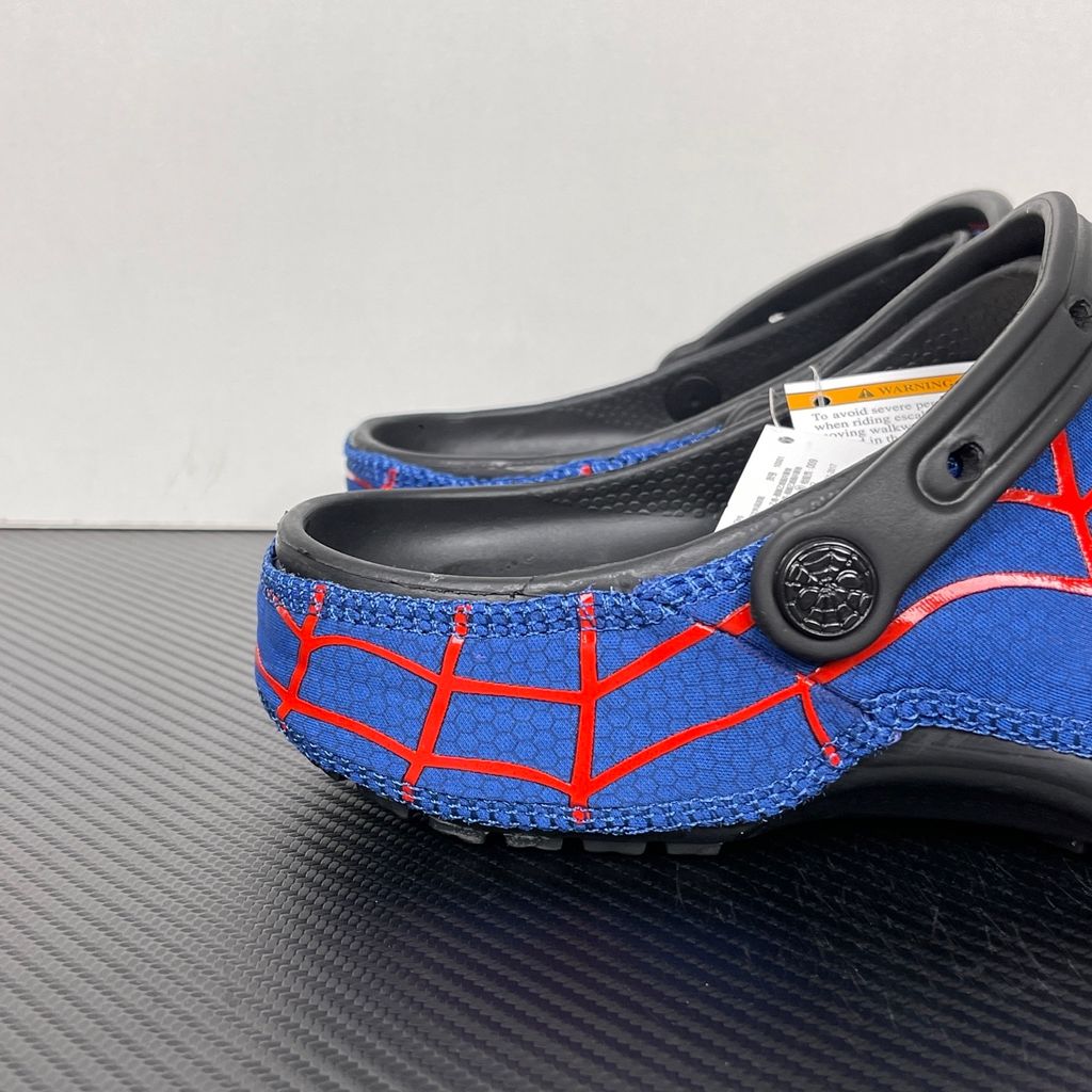 Crocs x Marvel Spider-Man Neo Classic Clog Multi 211489-90H with blue upper, red spider-web graphics, black pivoting heel strap and Spider-Man emblem.