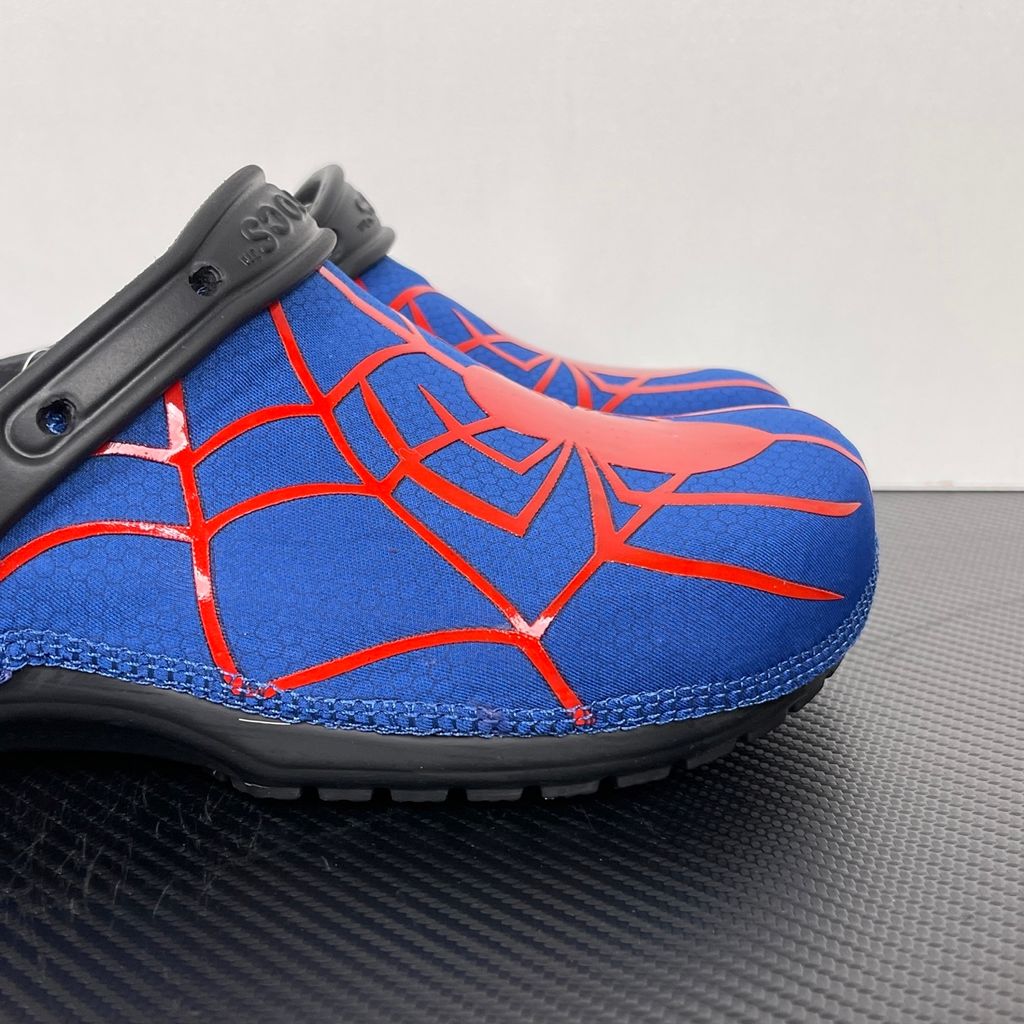 Crocs x Marvel Spider-Man Neo Classic Clog Multi 211489-90H with blue upper, red spider-web graphics, black pivoting heel strap and Spider-Man emblem.