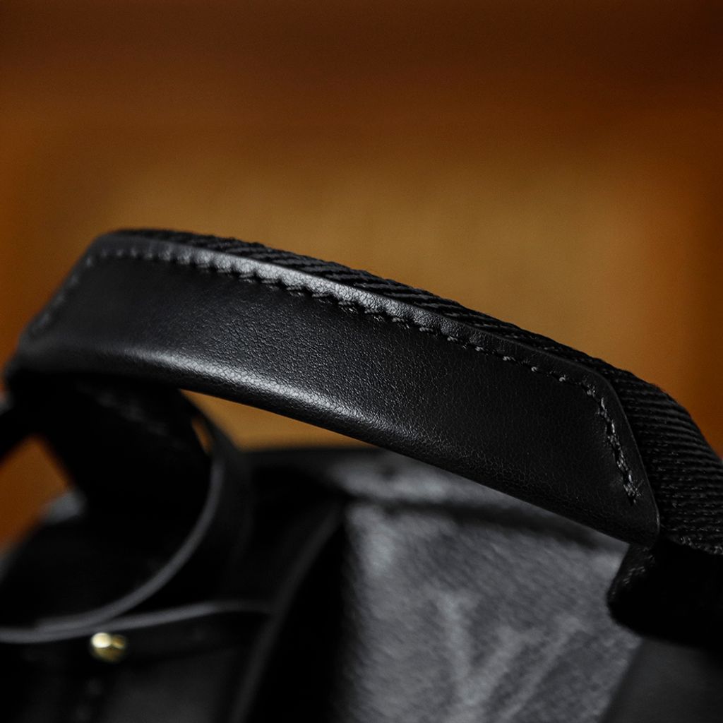 Front view of the authentic Louis Vuitton Discovery Backpack PM (image_b57668.jpg) featuring the iconic Monogram Eclipse grey and black coated canvas, a front zippered compartment, sleek black leather trim, and polished silver-tone hardware.