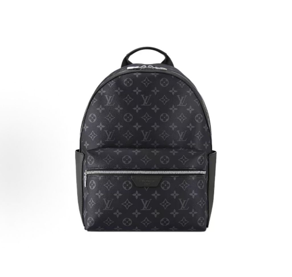 Front view of the authentic Louis Vuitton Discovery Backpack PM (image_b57668.jpg) featuring the iconic Monogram Eclipse grey and black coated canvas, a front zippered compartment, sleek black leather trim, and polished silver-tone hardware.