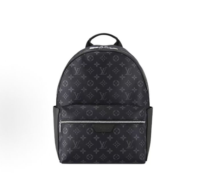 Front view of the authentic Louis Vuitton Discovery Backpack PM (image_b57668.jpg) featuring the iconic Monogram Eclipse grey and black coated canvas, a front zippered compartment, sleek black leather trim, and polished silver-tone hardware.