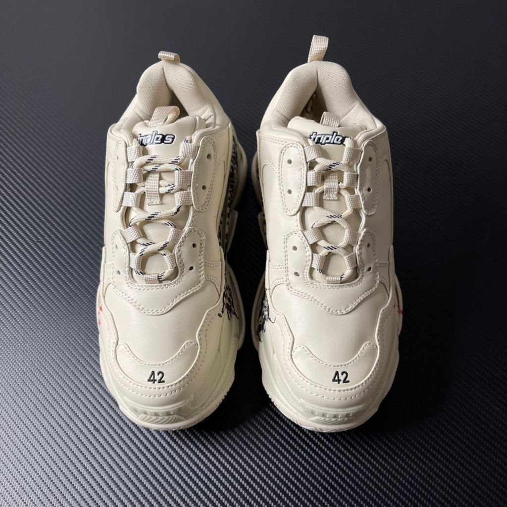 Balenciaga Triple S Graffiti Off-White 536737W2FAY9016 luxury chunky sneaker with red graffiti logo, side profile view.