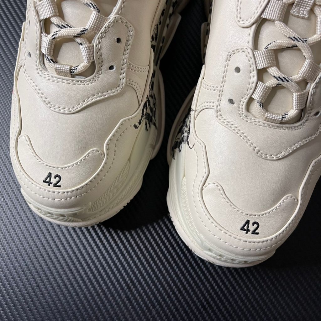 Balenciaga Triple S Graffiti Off-White 536737W2FAY9016 luxury chunky sneaker with red graffiti logo, side profile view.