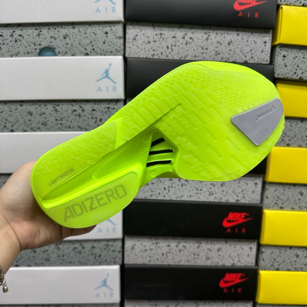 Shop adidas Adizero Adios Pro 4 JR6364 in Lucid Lemon, Core Black and Halo Silver with LIGHTSTRIKE PRO, ENERGYRODS 2.0 and Continental race traction.