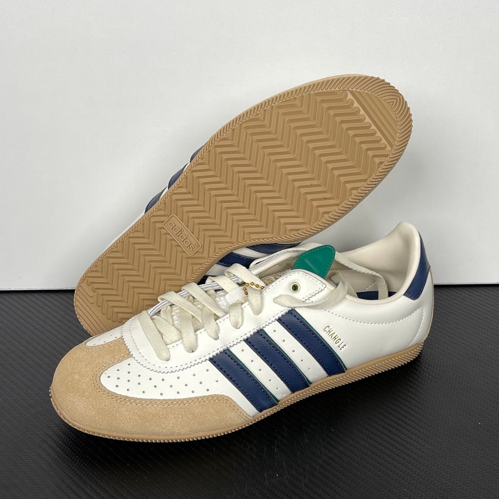 Shop adidas Chang Le LA1355 in Core White and Warm Sandstone with perforated tumbled leather, double-stitched T-toe detailing and a low-profile retro silhouette.